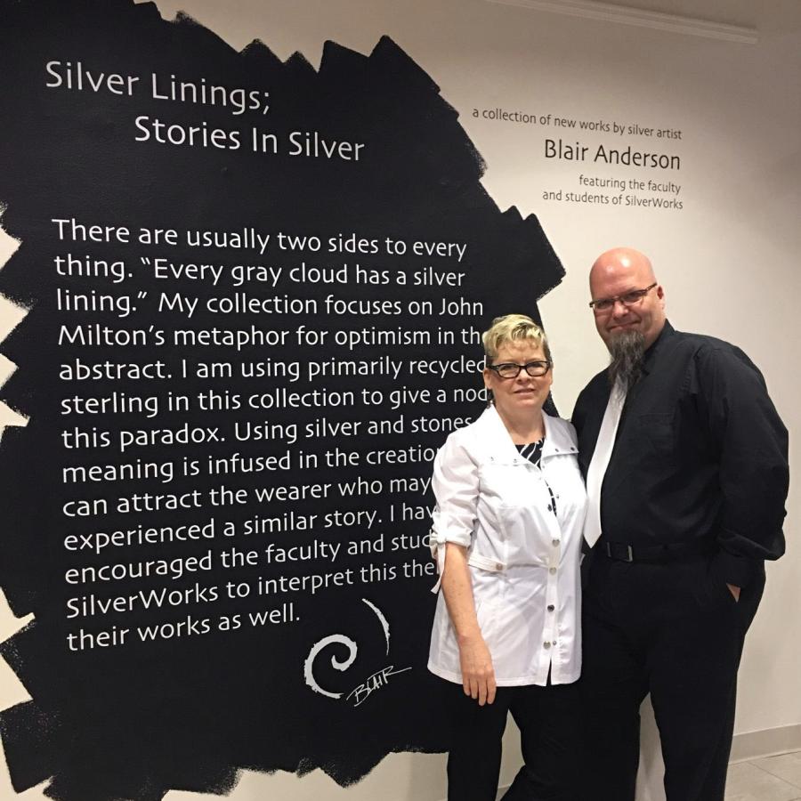 Blair and Bray in front of show title wall
