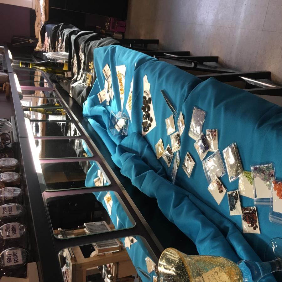 packets of gems laid out on teal cloth