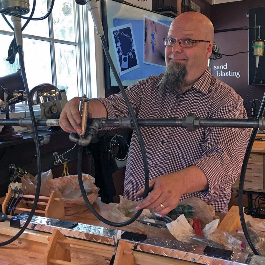 Bryan installing black steampunk piping to hold flexishaft drills