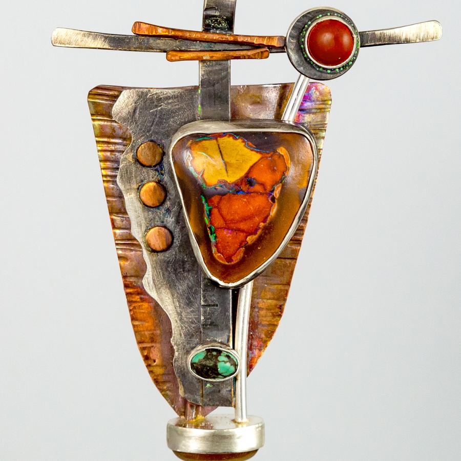 pendant with copper silver and orange and red stones