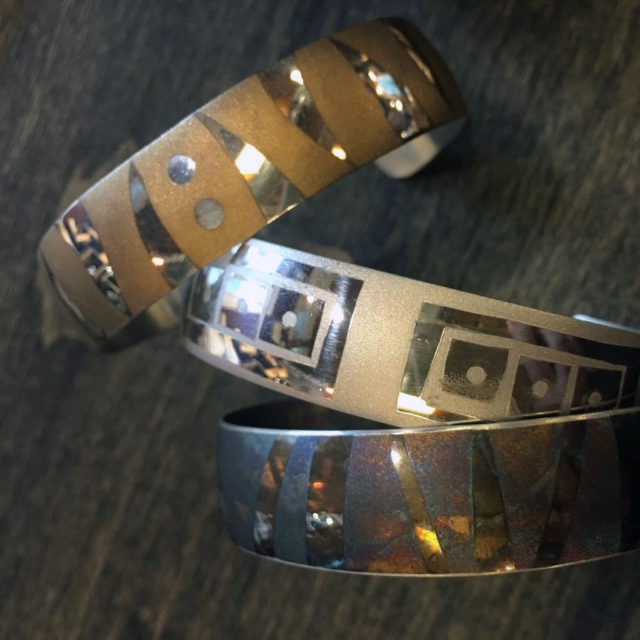 bracelet cuffs with sand blasted patterns and oxidized with liver of sulfur