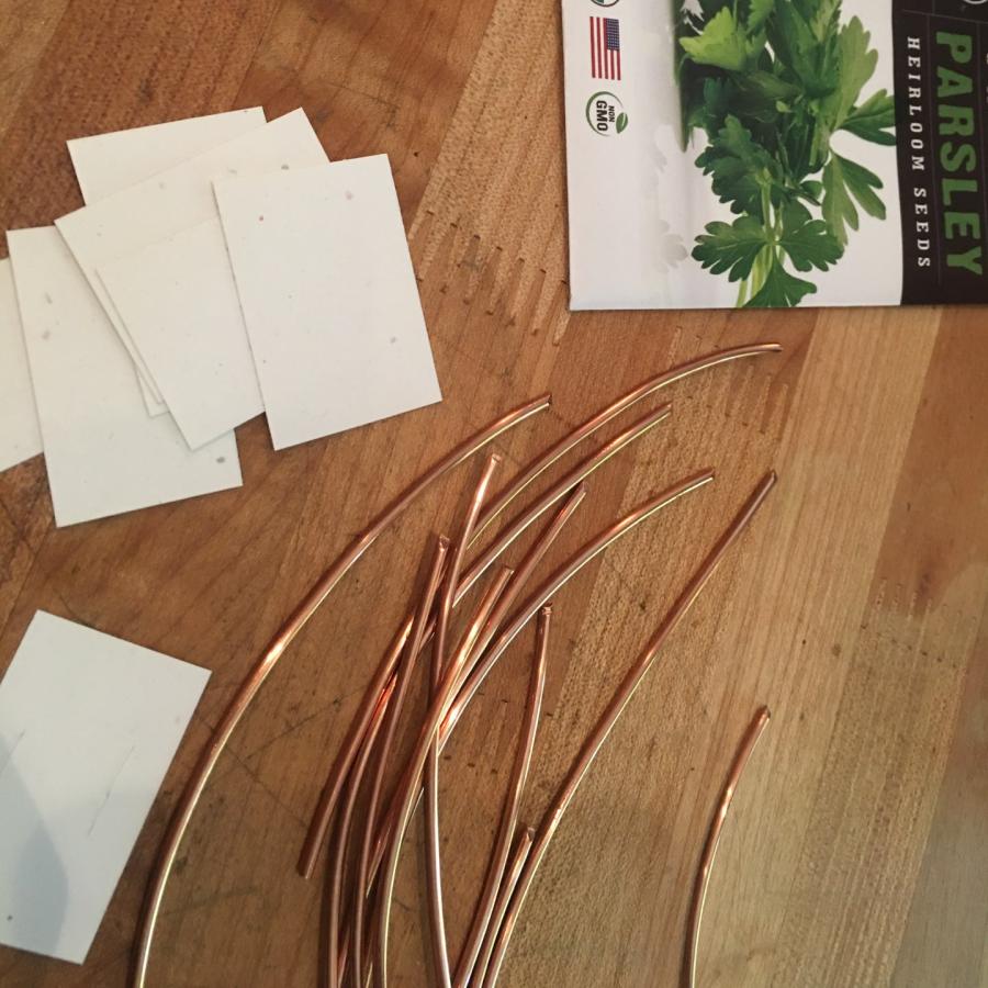 copper wire and white card stock for labels next to parsley seeds