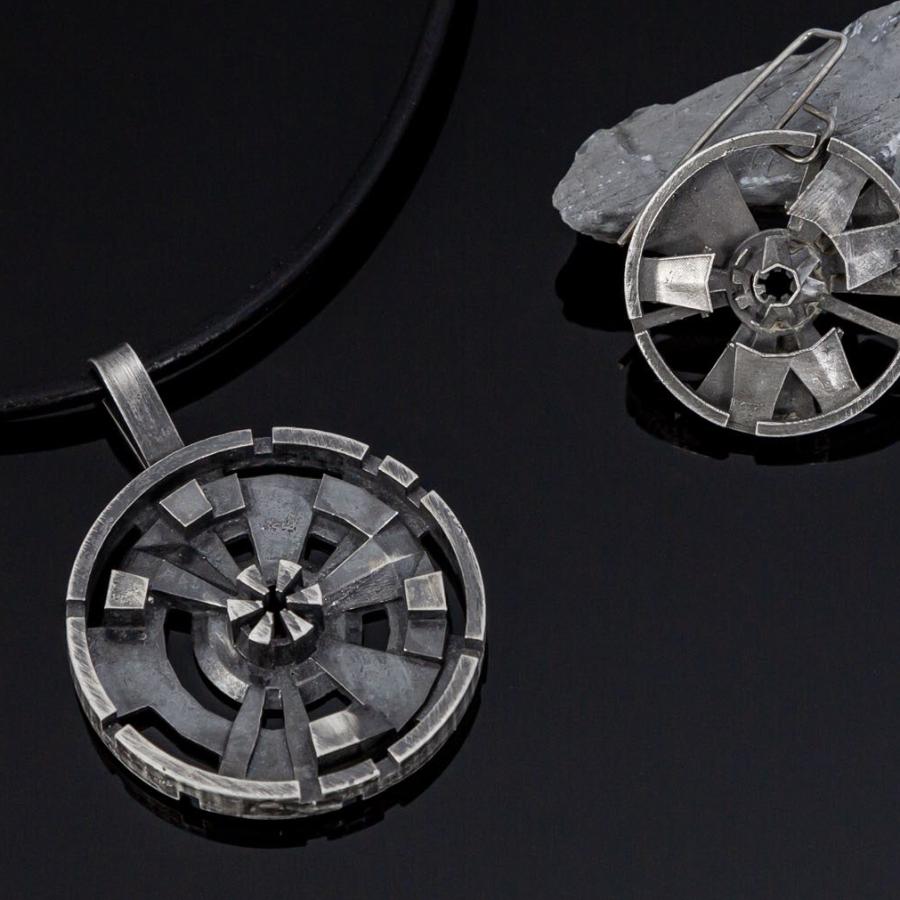 sterling silver "data ports" displayed on rock and as pendant