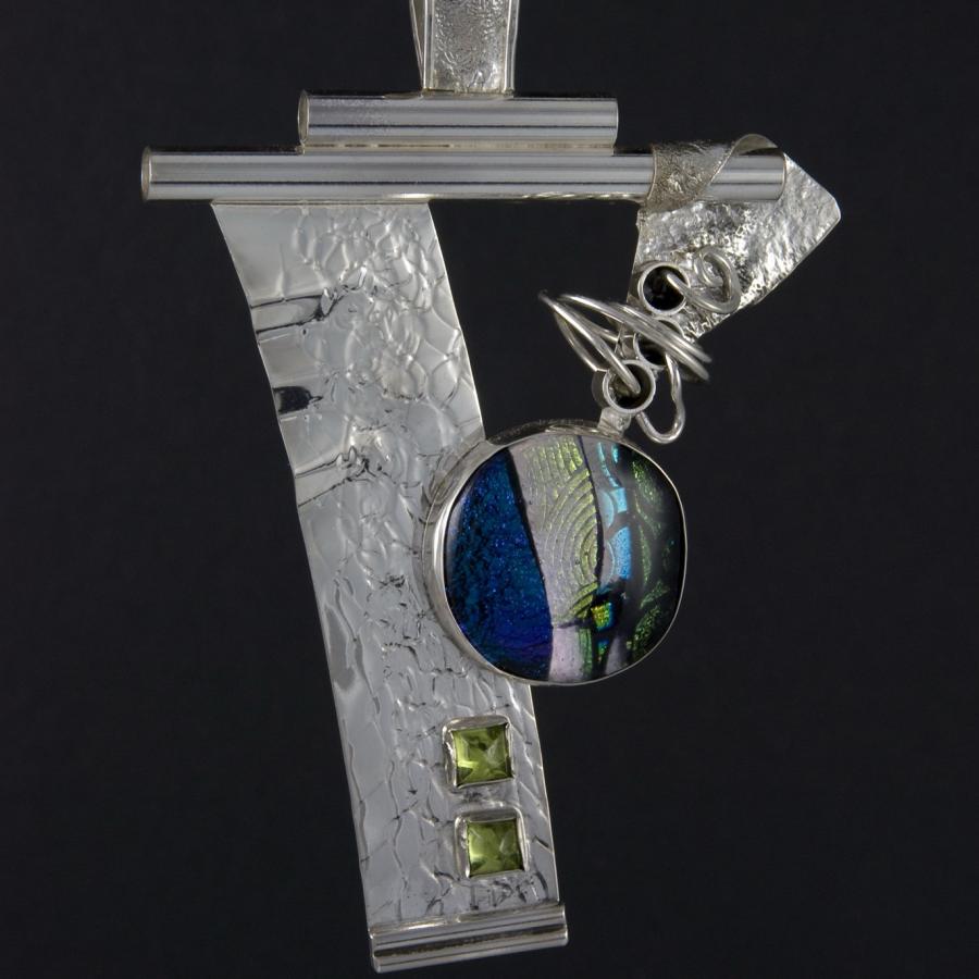 Silver artistic necklace with glass and stone accents.