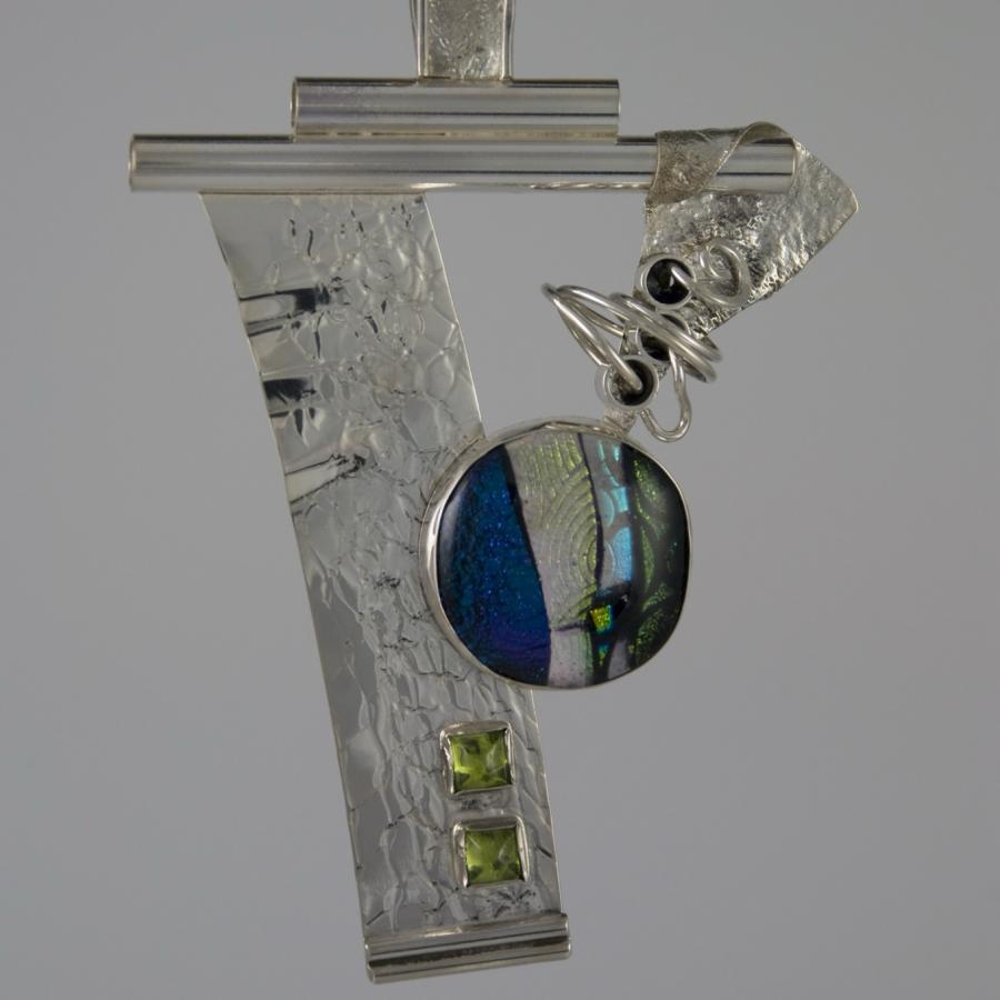Silver artistic necklace with glass and stone accents.