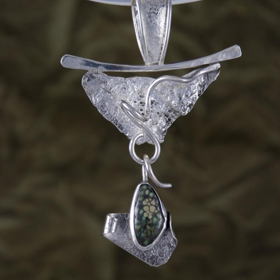 Silver and dinosaur bone pendant