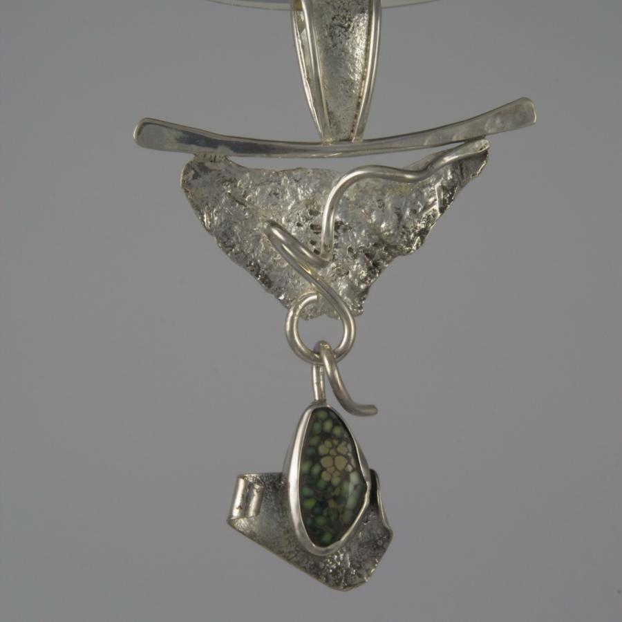 Silver and dinosaur bone pendant