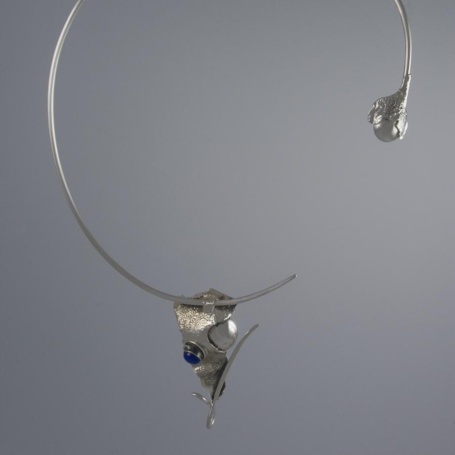 Silver open collar necklace with blue stone.