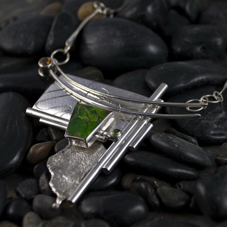 Oil spill pendant on river rocks