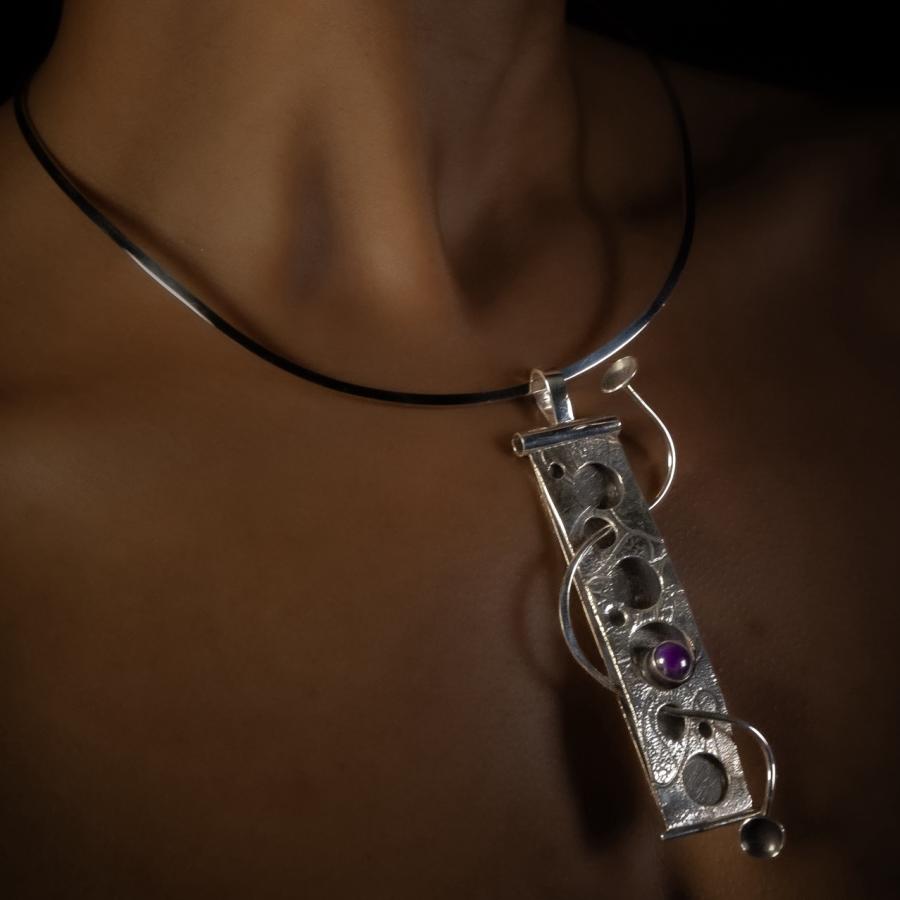 Woman wears jewelry, necklace and earring.