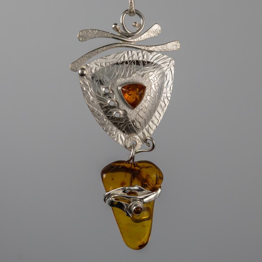 Silver pendant with yellow stones