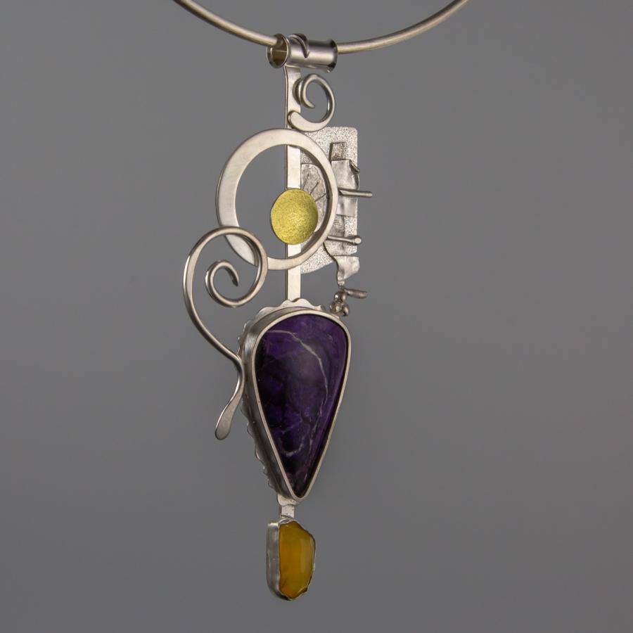 Necklace pendant with purple and yellow stones.