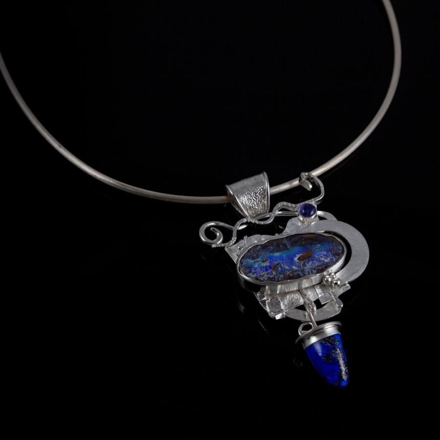 Silver pendant necklace with blue stones.