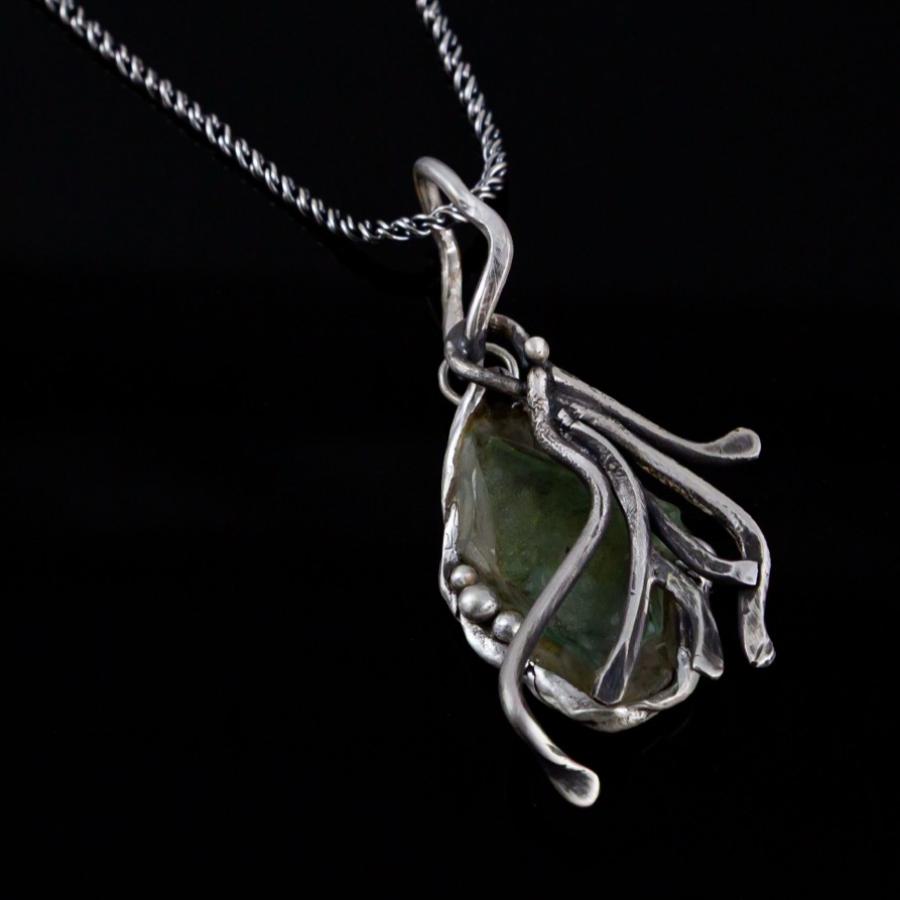 Silver pendant with green glass
