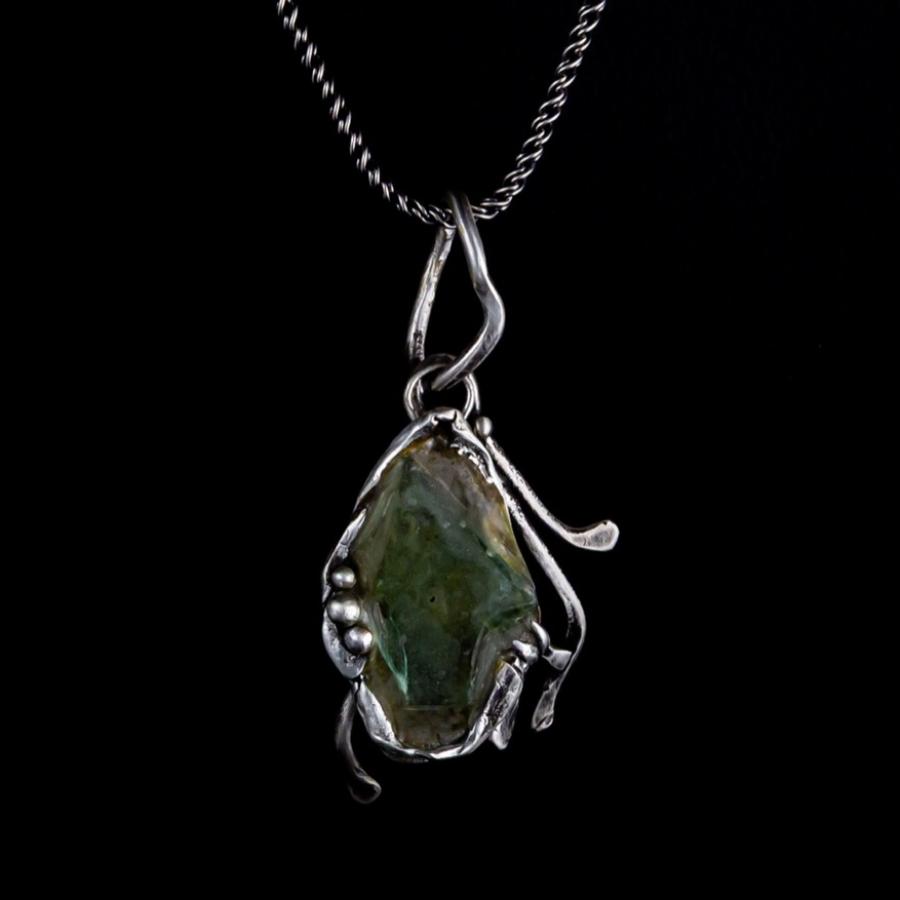 Silver pendant with green glass