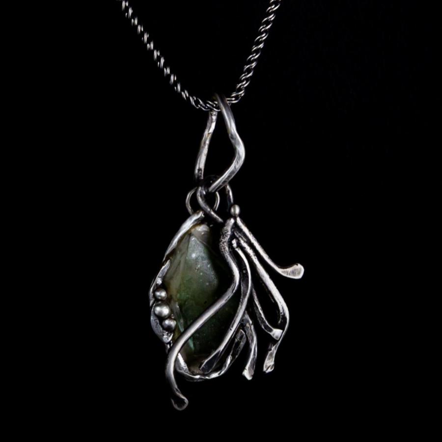 Silver pendant with green glass