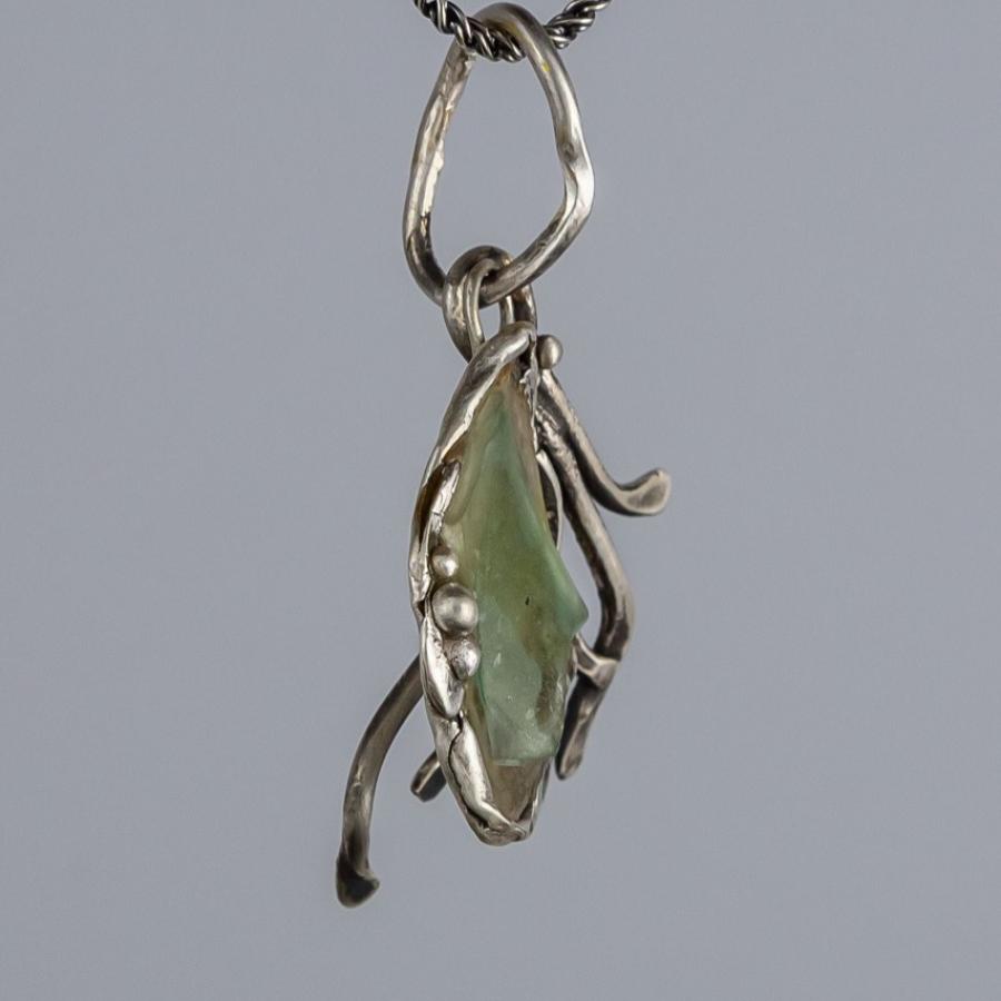 Silver pendant with green glass