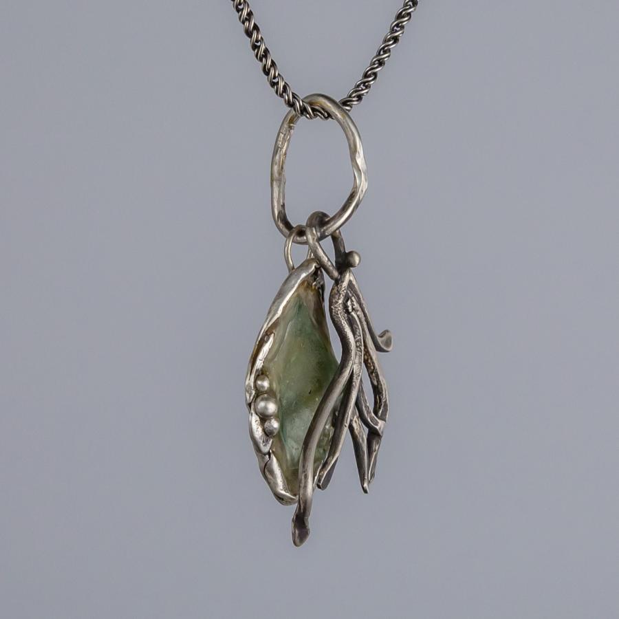 Silver pendant with green glass