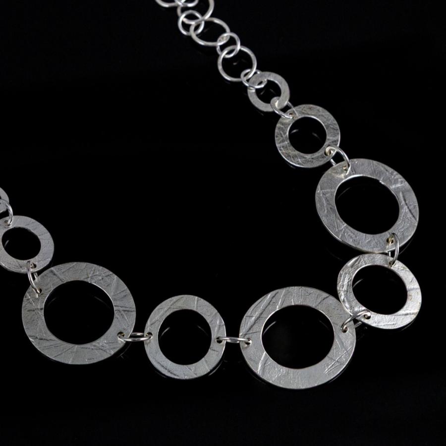 Silver necklace with textured circular links.