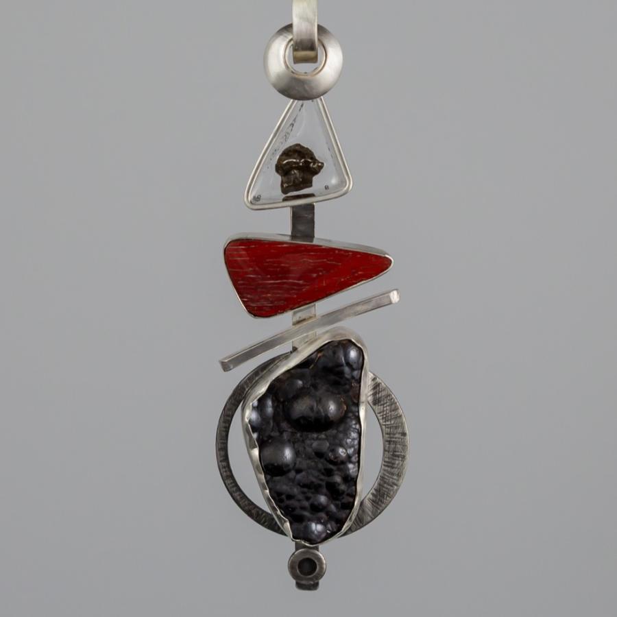 Silver pendant with black and red stones