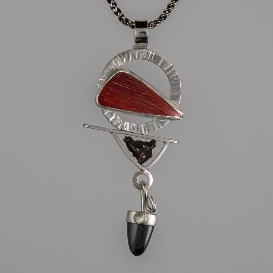 Silver pendant with black and red stones