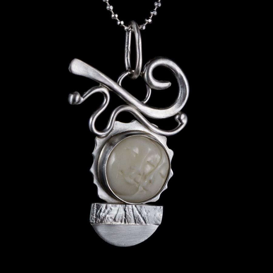 Silver pendant with carved ivory moon face