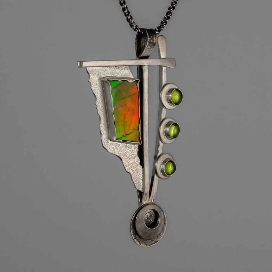 Silver pendant with several stones