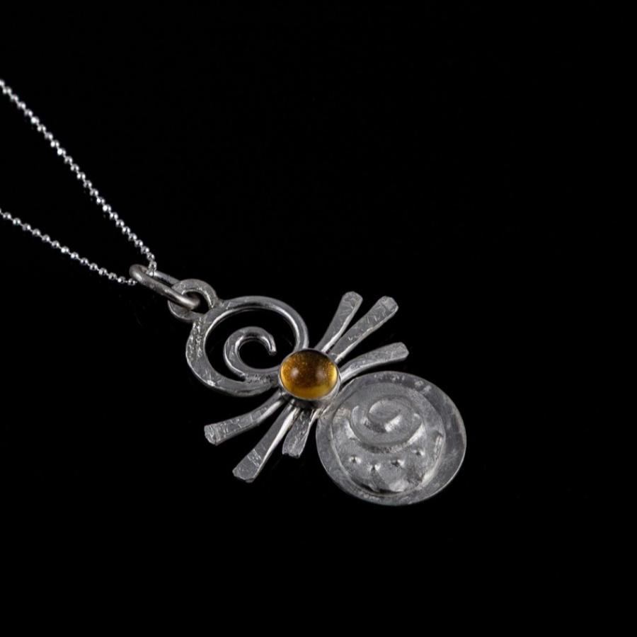 Silver pendant with yellow stone