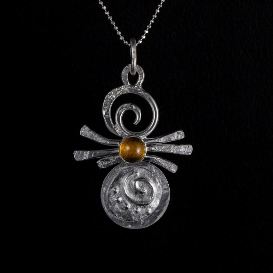 Silver pendant with yellow stone