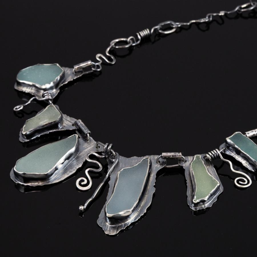 Handmade sea glass and silver necklace, photograph.