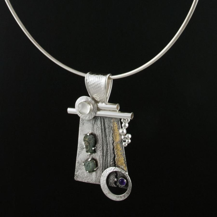 Silver necklace with unique pendant.