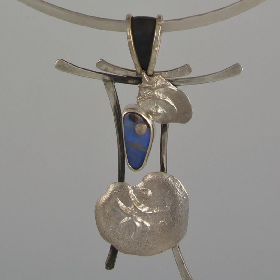 Necklace with silver pendant, abstract design.