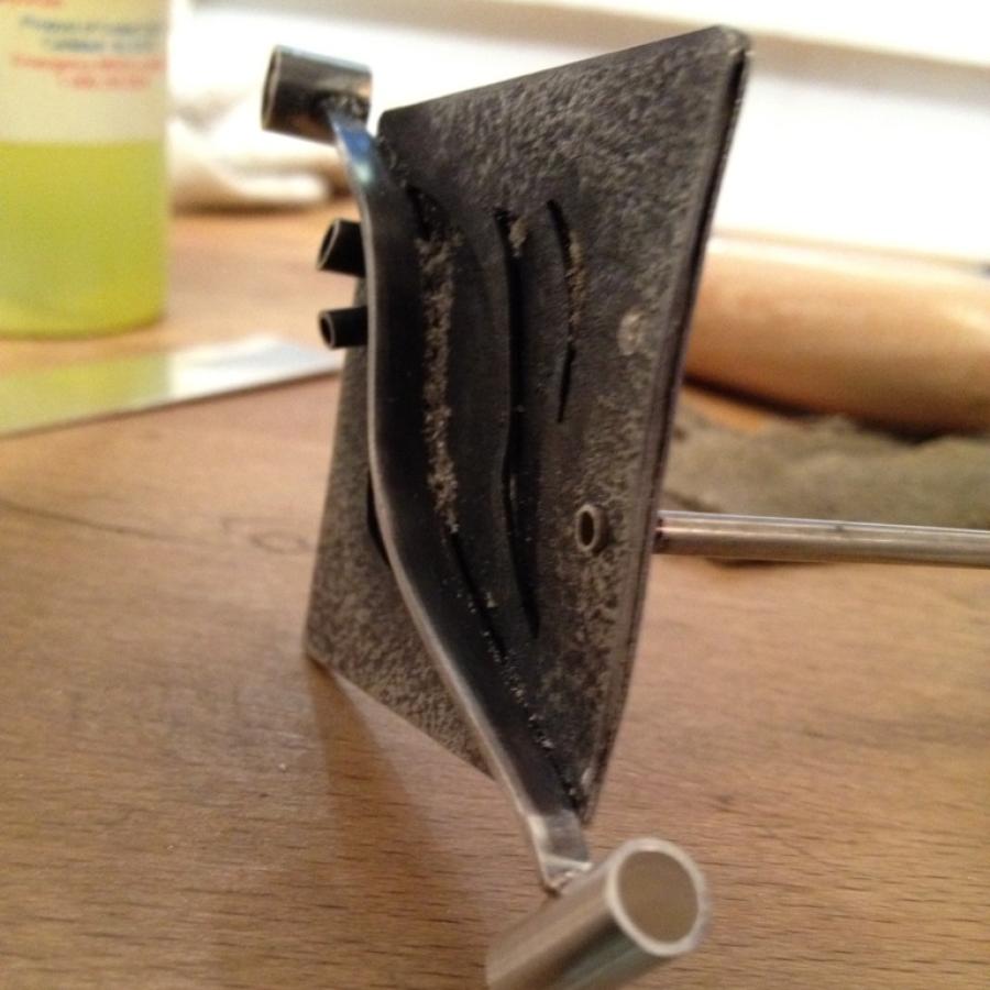 Jewelery design in process on wood workbench.