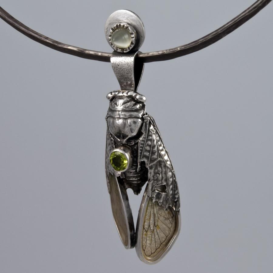 Silver cicada pendant necklace, green gemstone accent.