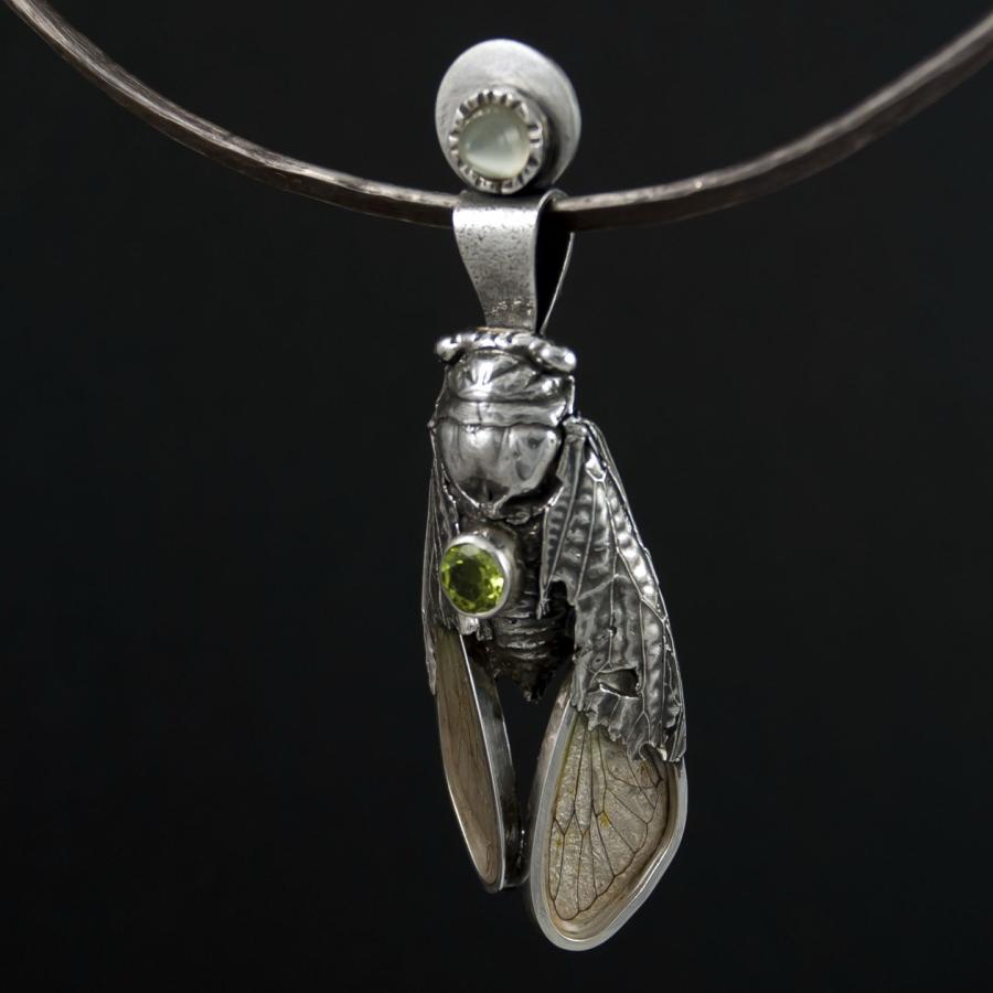 Silver necklace with an insect pendant.