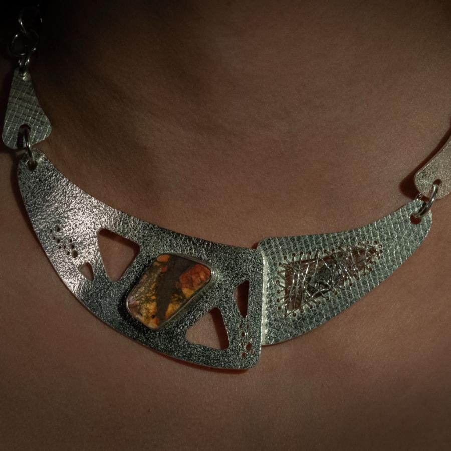 Silver necklace with jasper and meteorite worn by a model.
