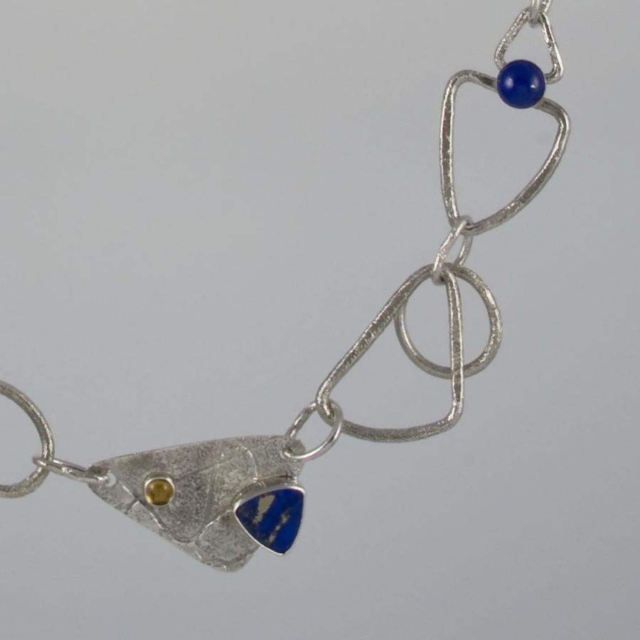 Silver necklace with blue and yellow stones.