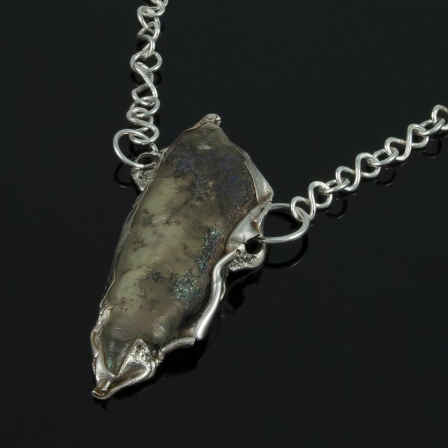 Silver chain necklace with a unique pendant.