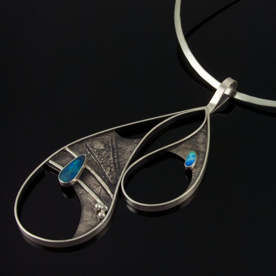 Silver necklace with asymmetrical teardrop shapes and opal.