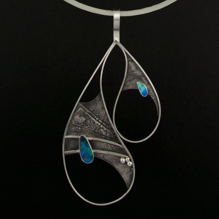 Silver necklace with asymmetrical teardrop shapes and opal.