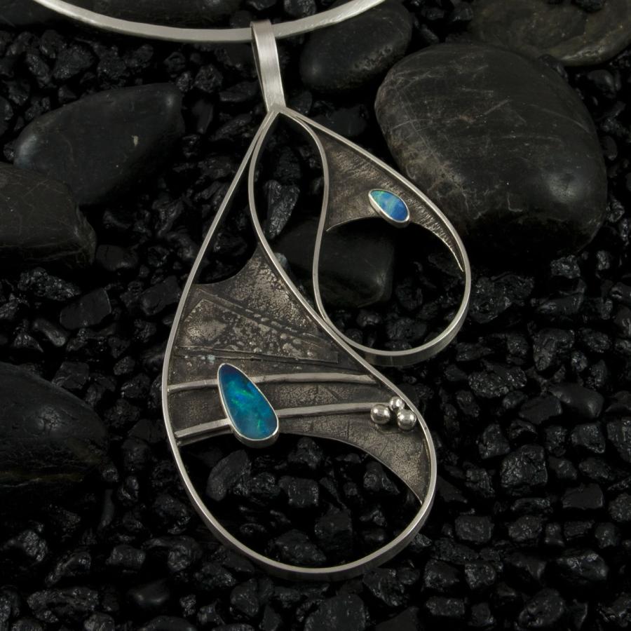 Silver necklace with asymmetrical teardrop shapes and opal.