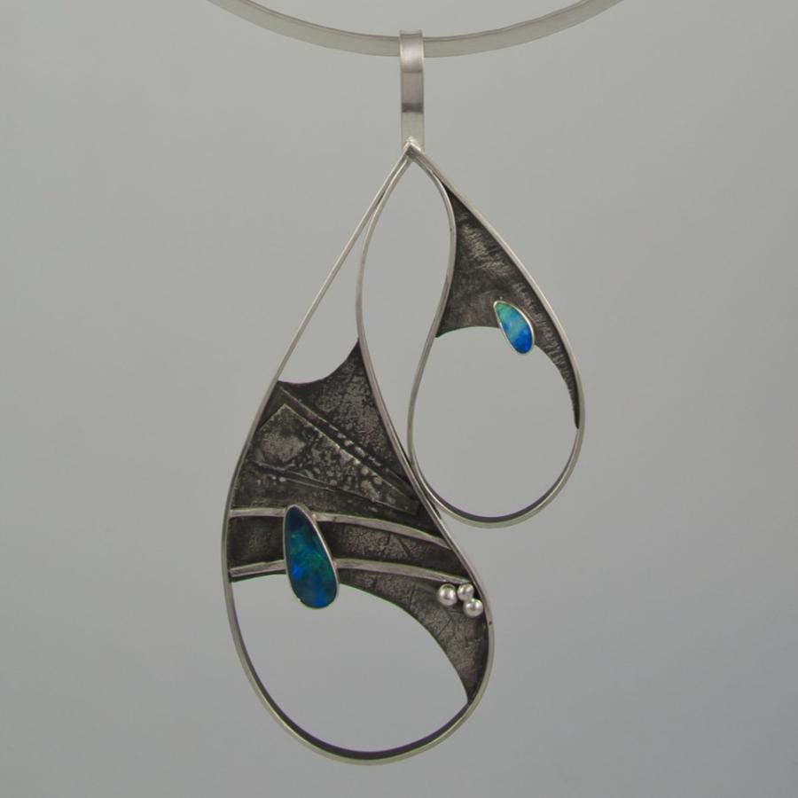 Silver necklace with asymmetrical teardrop shapes and opal.