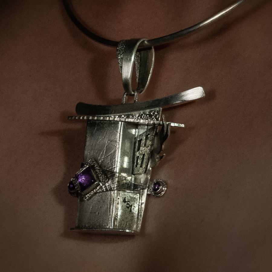 Silver necklace with abstract pendant.