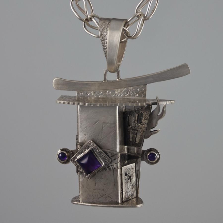 Silver necklace with abstract pendant.