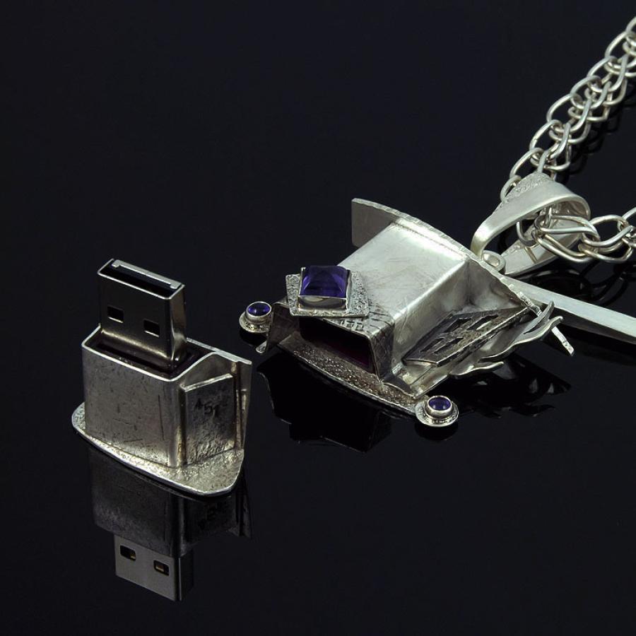 Silver necklace with pendant and matching USB drive.