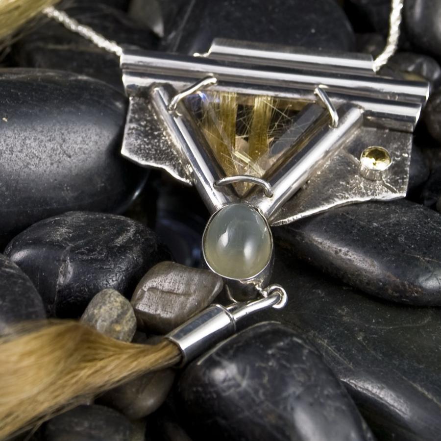 Necklace with a lock of hair on black stones, photograph.