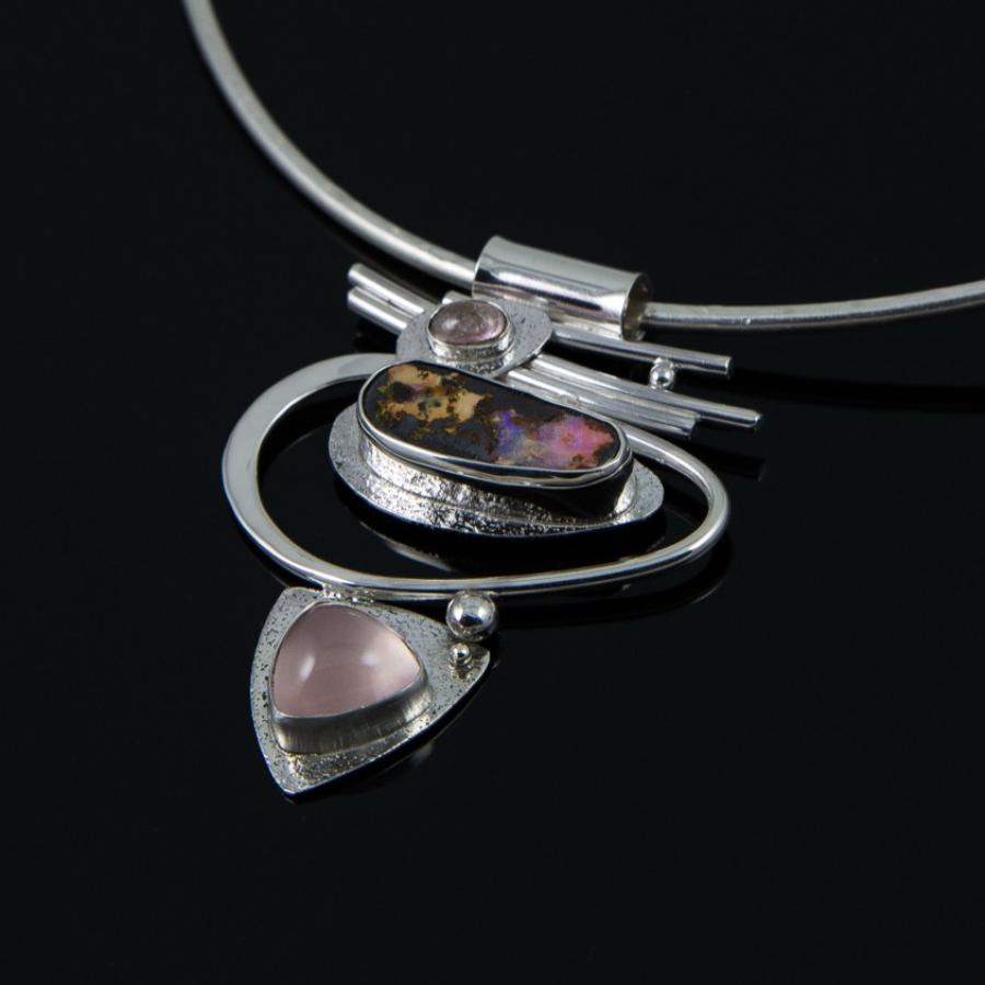 Silver necklace with opal and rose quartz pendant.