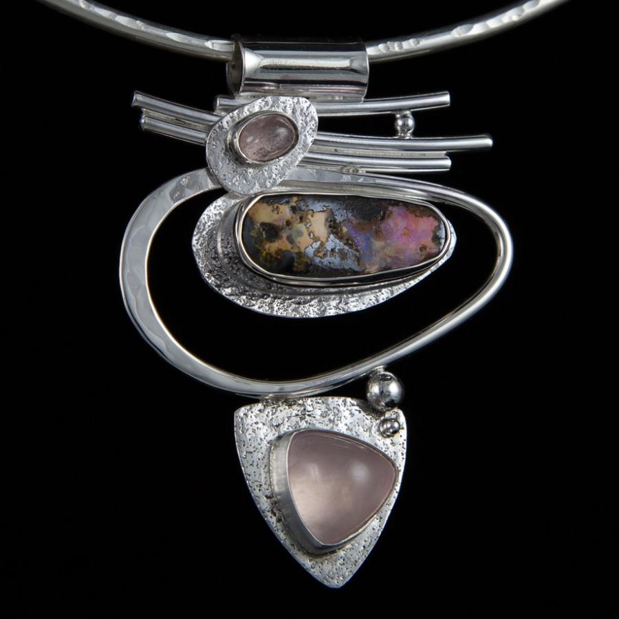 Artisan silver pendant necklace with colorful stones.