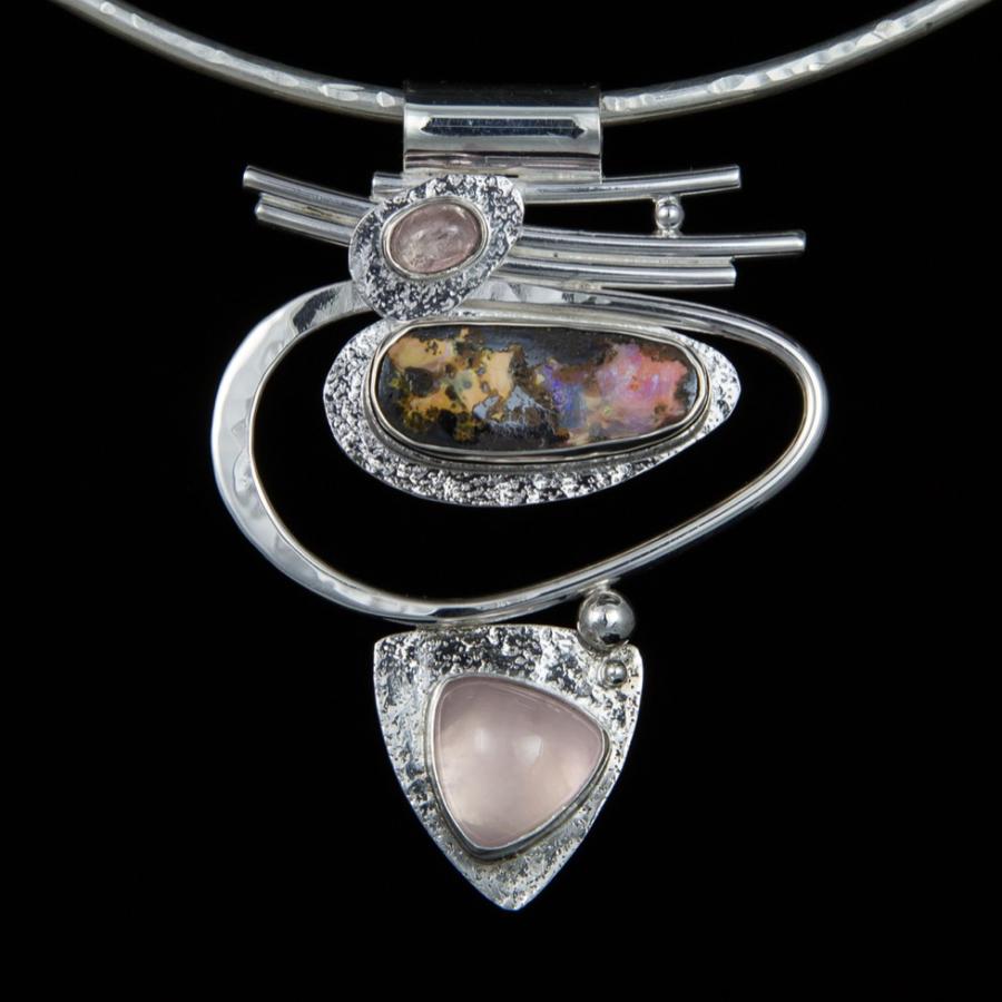 Silver necklace with opal and pink stones.