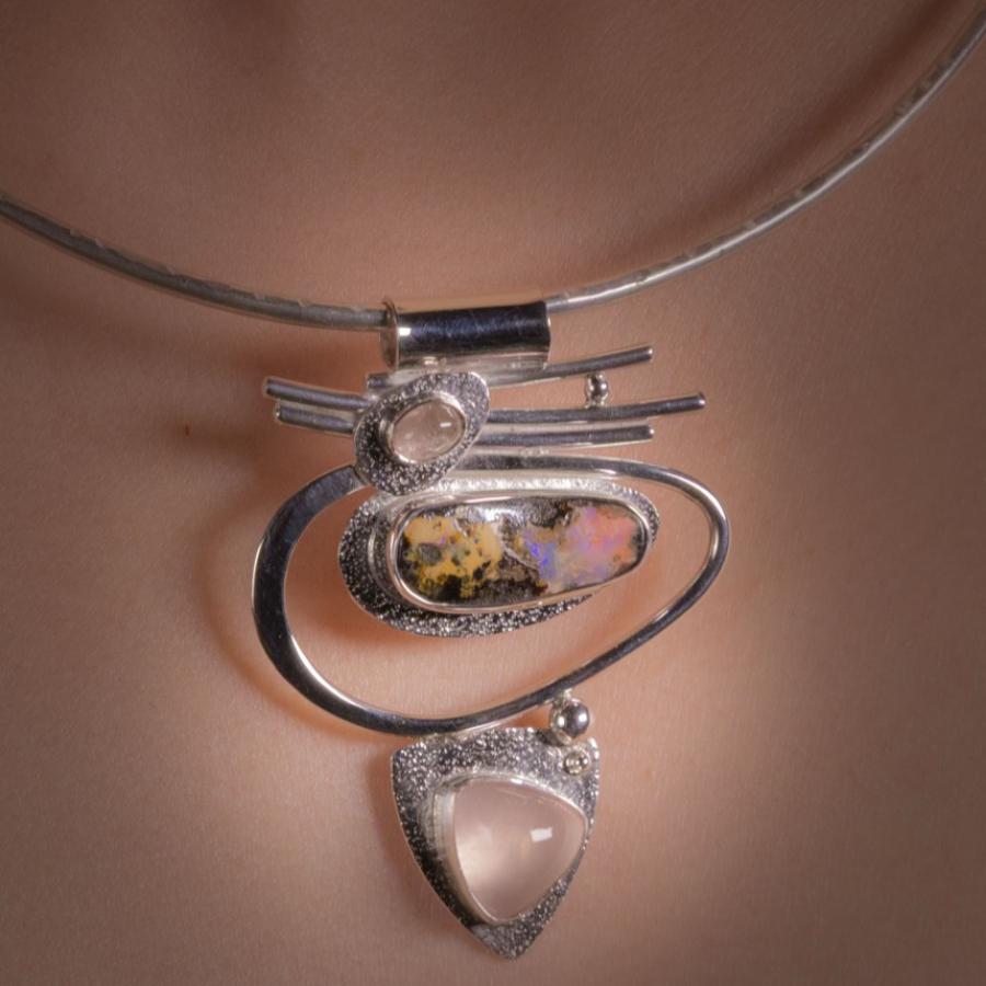 Silver necklace on a person.